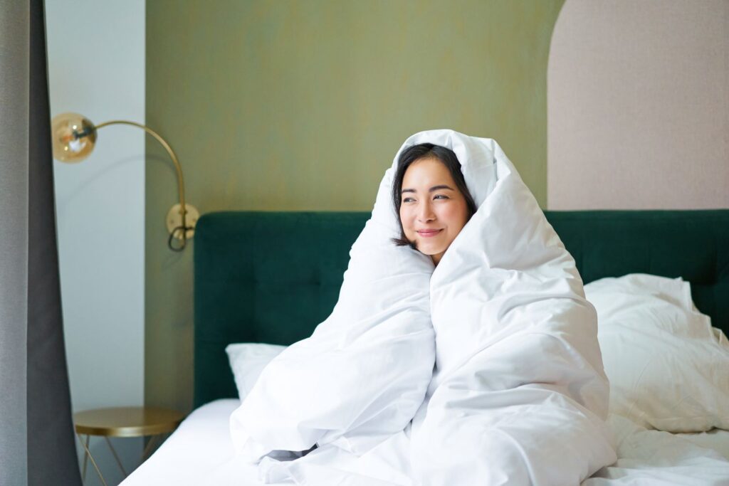 woman cuddled in duvet