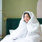 woman cuddled in duvet