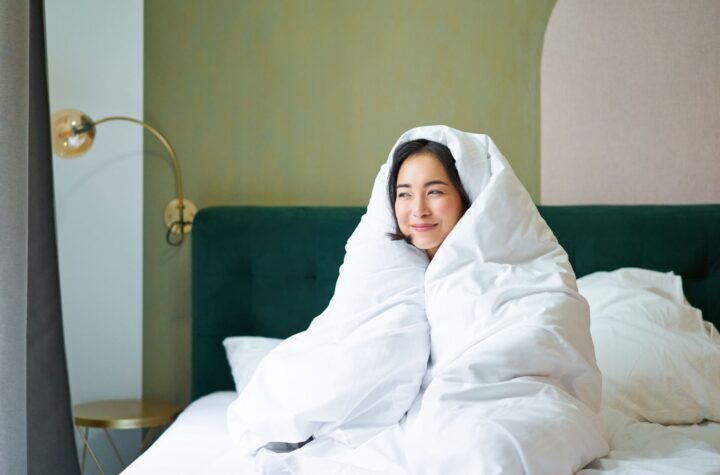 woman cuddled in duvet